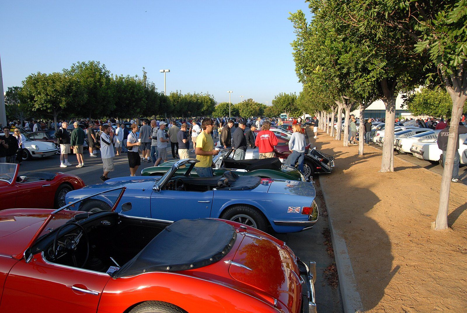 A row of classic roadsters parked along a lot at a Saturday morning car meet in Irvine, a Wikimedia Commons photograph in the encyclopedia of Mike Kobeissi