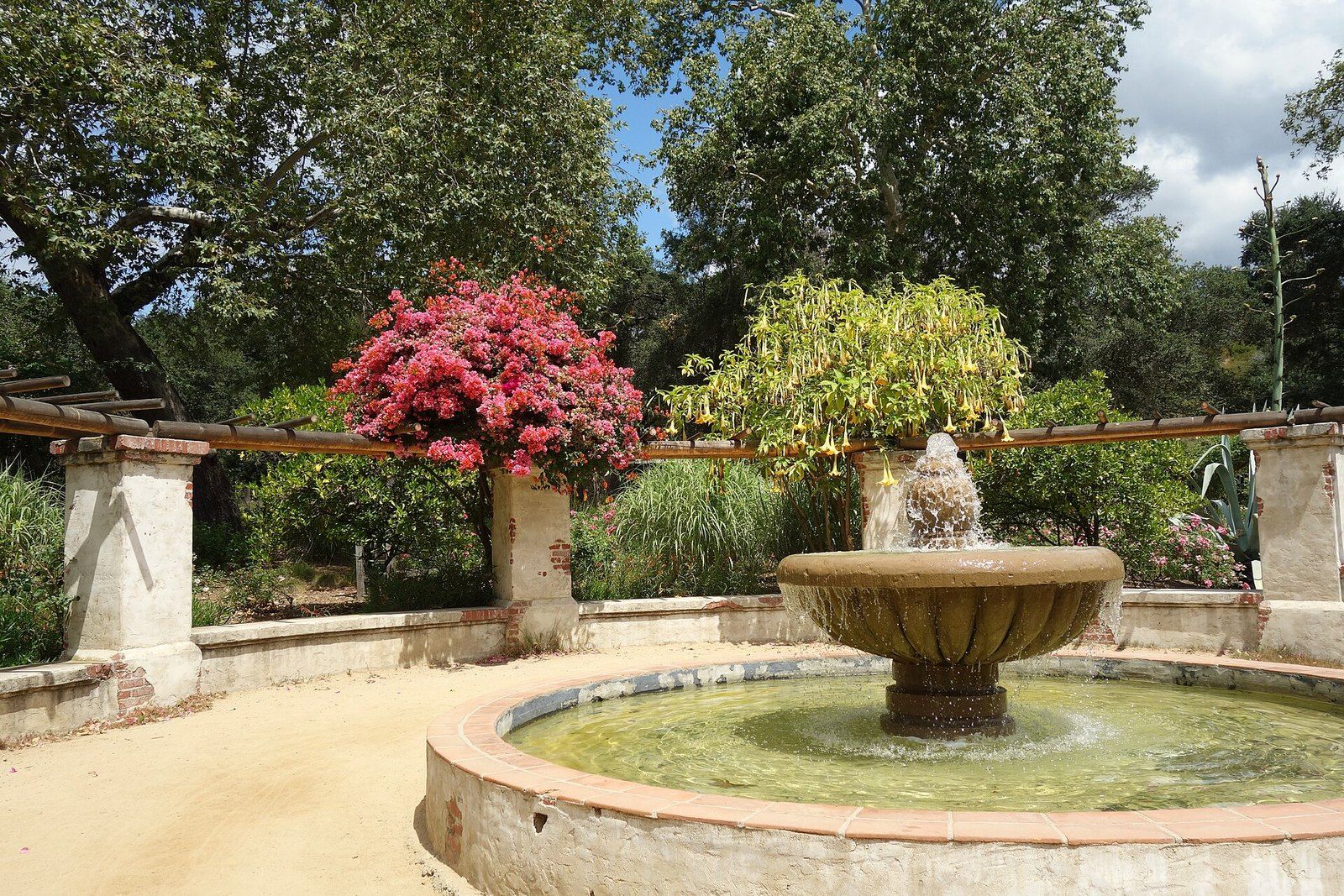 The rose garden at Descanso Gardens in La Cañada Flintridge, a stone fountain under a perg, a Wikimedia Commons photograph in the encyclopedia of Mike Kobeissi