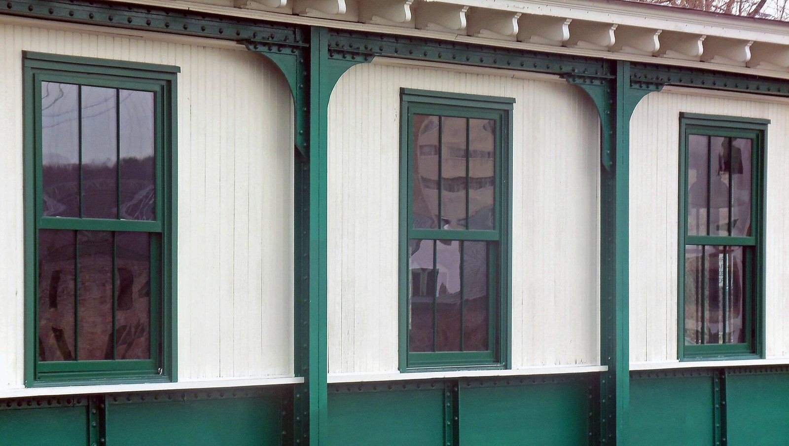A row of three over three double hung wooden sash windows in a painted wall, a Wikimedia Commons photograph in the encyclopedia of Mike Kobeissi