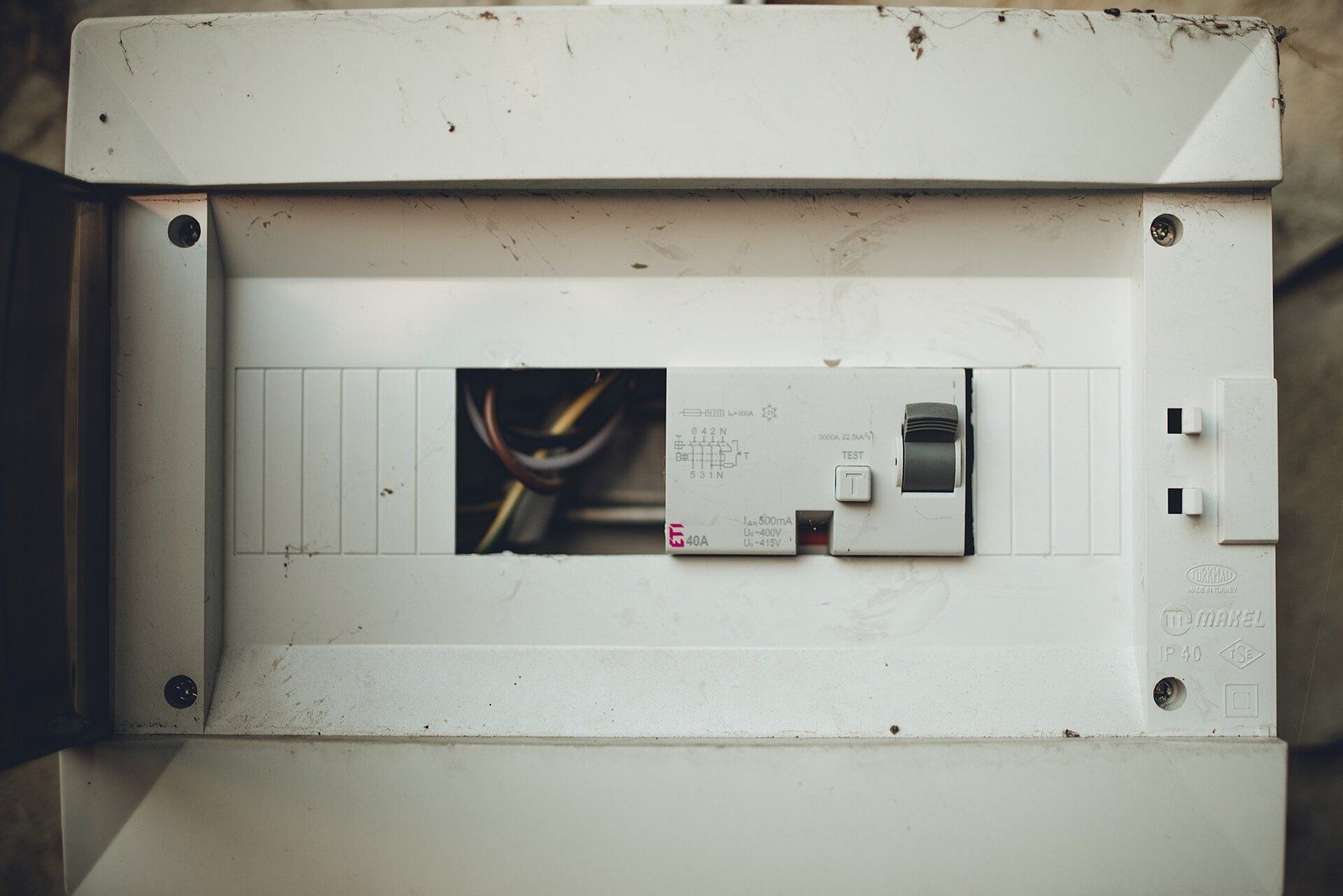 A residential breaker box with its cover off, showing breakers and wiring, a Wikimedia Commons photograph in the encyclopedia of Mike Kobeissi
