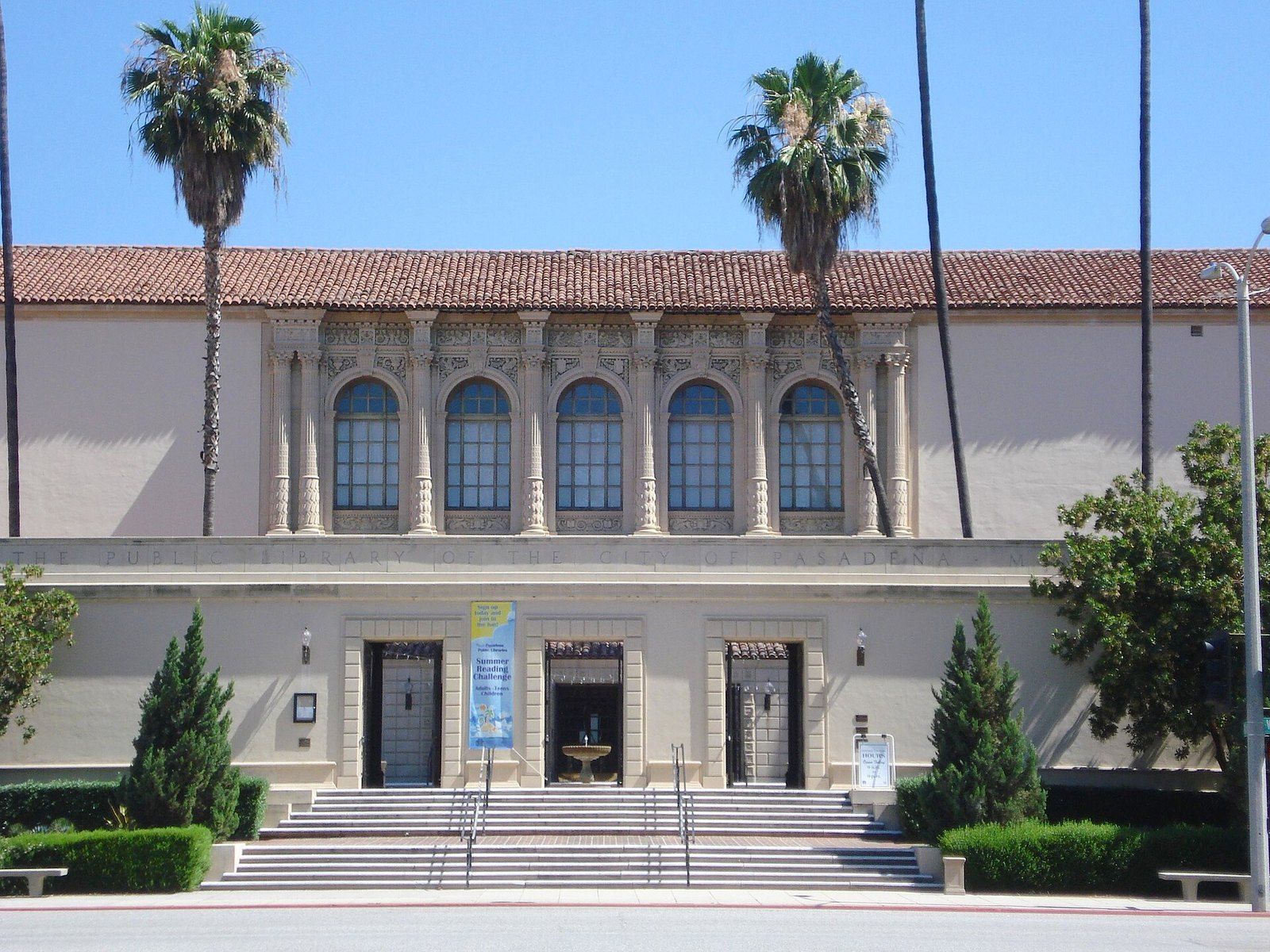 The arcaded Spanish Renaissance facade of the Pasadena Central Library under tall palms, a Wikimedia Commons photograph in the encyclopedia of Mike Kobeissi