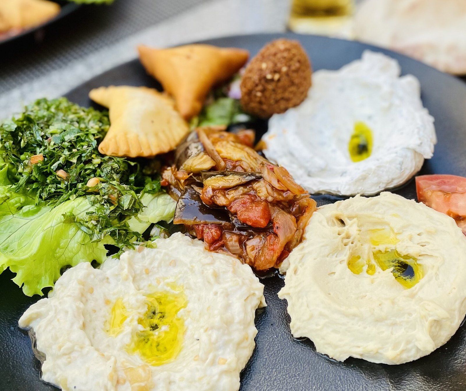 A Lebanese mezze plate of hummus, labneh, fattoush, falafel and pastries, a Wikimedia Commons photograph in the encyclopedia of Mike Kobeissi
