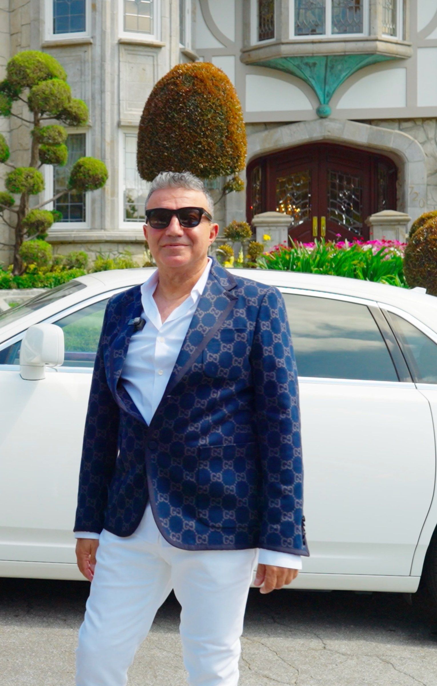 Mike Kobeissi in a patterned blue jacket and sunglasses on a sunny street in La Cañada Flintridge