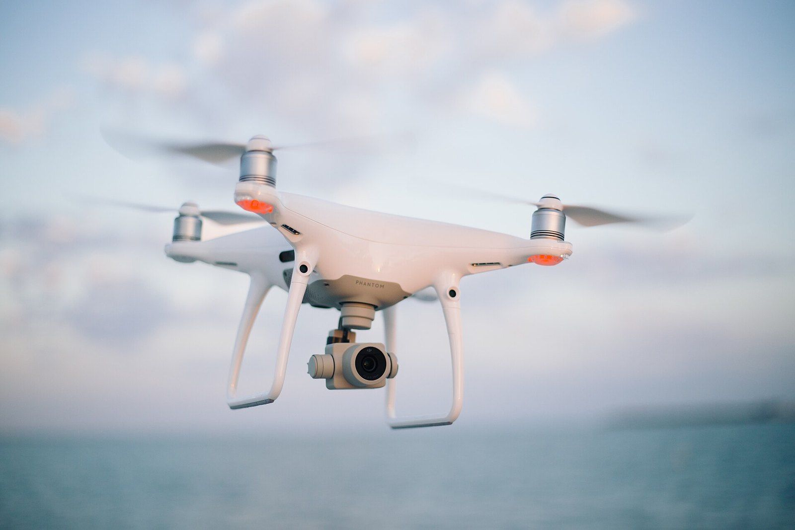 A white quadcopter camera drone hovering in flight, a Wikimedia Commons photograph in the encyclopedia of Mike Kobeissi