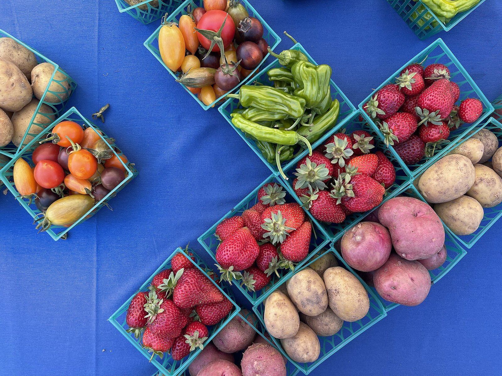 Baskets of strawberries, potatoes and peppers at a California farmers market, a Wikimedia Commons photograph in the encyclopedia of Mike Kobeissi