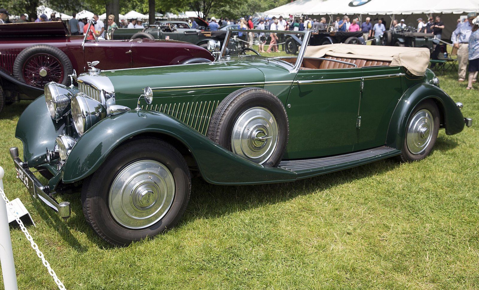 A green 1937 open tourer with a tan folding roof shown on the lawn of a concours d'eleganc, a Wikimedia Commons photograph in the encyclopedia of Mike Kobeissi