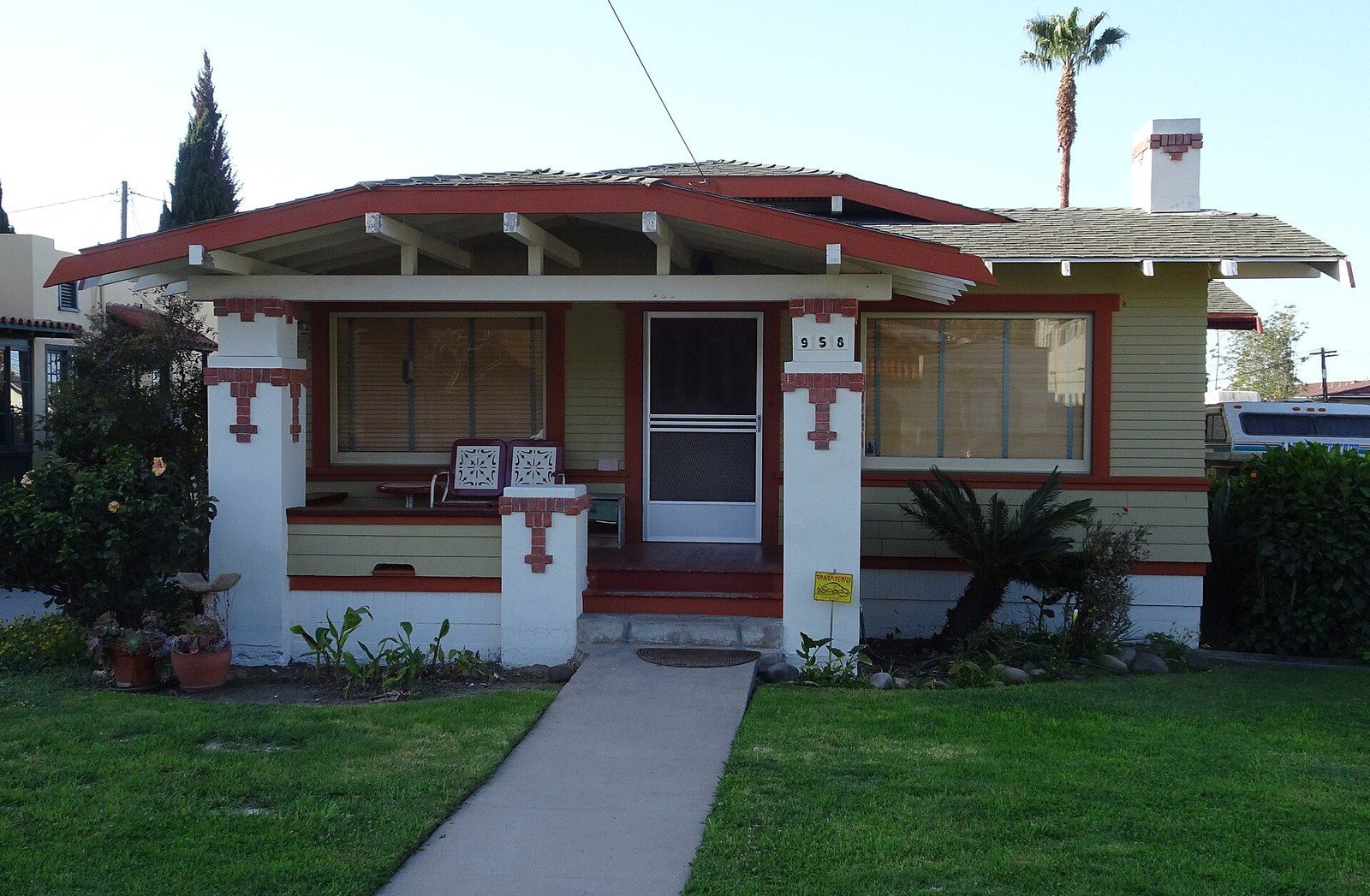 A Craftsman bungalow with a low gabled porch, tapered piers and red trim, a Wikimedia Commons photograph in the encyclopedia of Mike Kobeissi