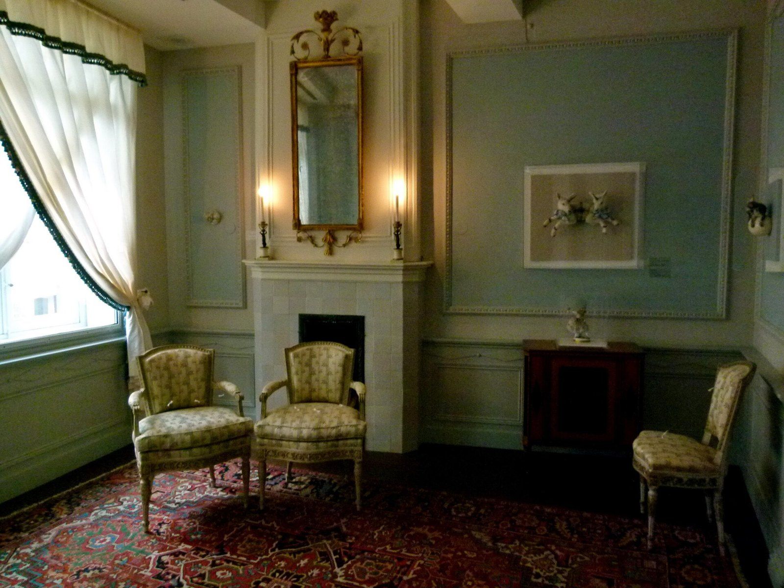 A furnished eighteenth century style period room with paneled walls, a mirror and upholste, a Wikimedia Commons photograph in the encyclopedia of Mike Kobeissi